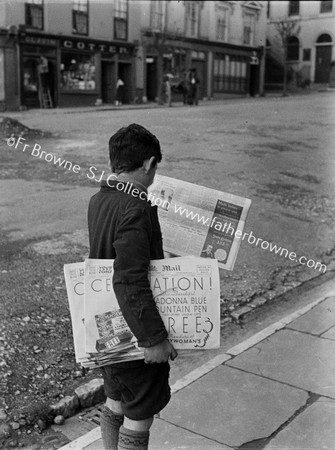 NEWSBOY READING 'MAIL' COTTER'S SHOP IN BACKGROUND